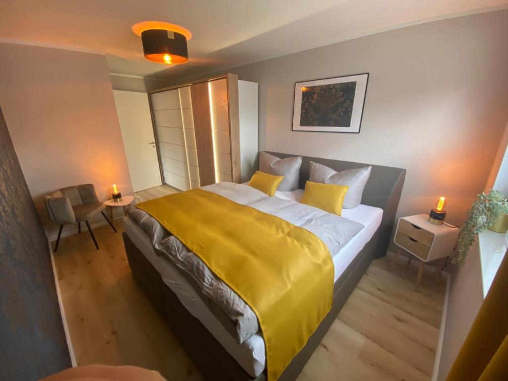 科特布斯Spree Chalet Cottbus的一间卧室配有一张带黄色毯子的大床