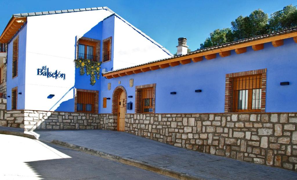 PeñalbaEl Balsetón的蓝色和白色的房屋,设有石墙