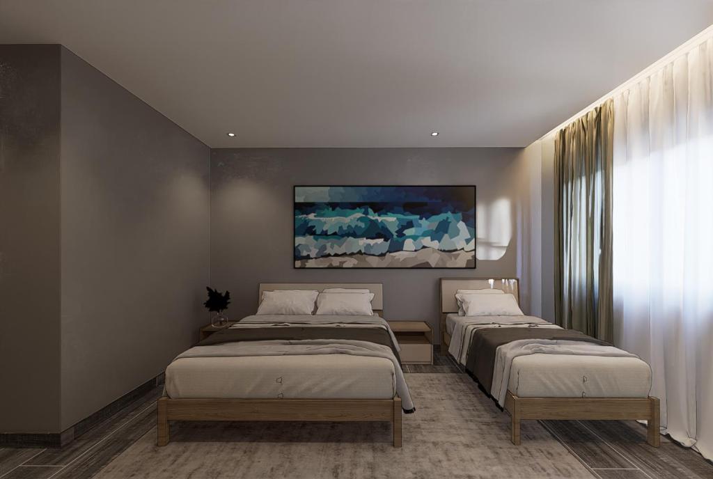 都拉斯Split Rooftop Suites的一间卧室设有两张床,墙上挂着一幅画