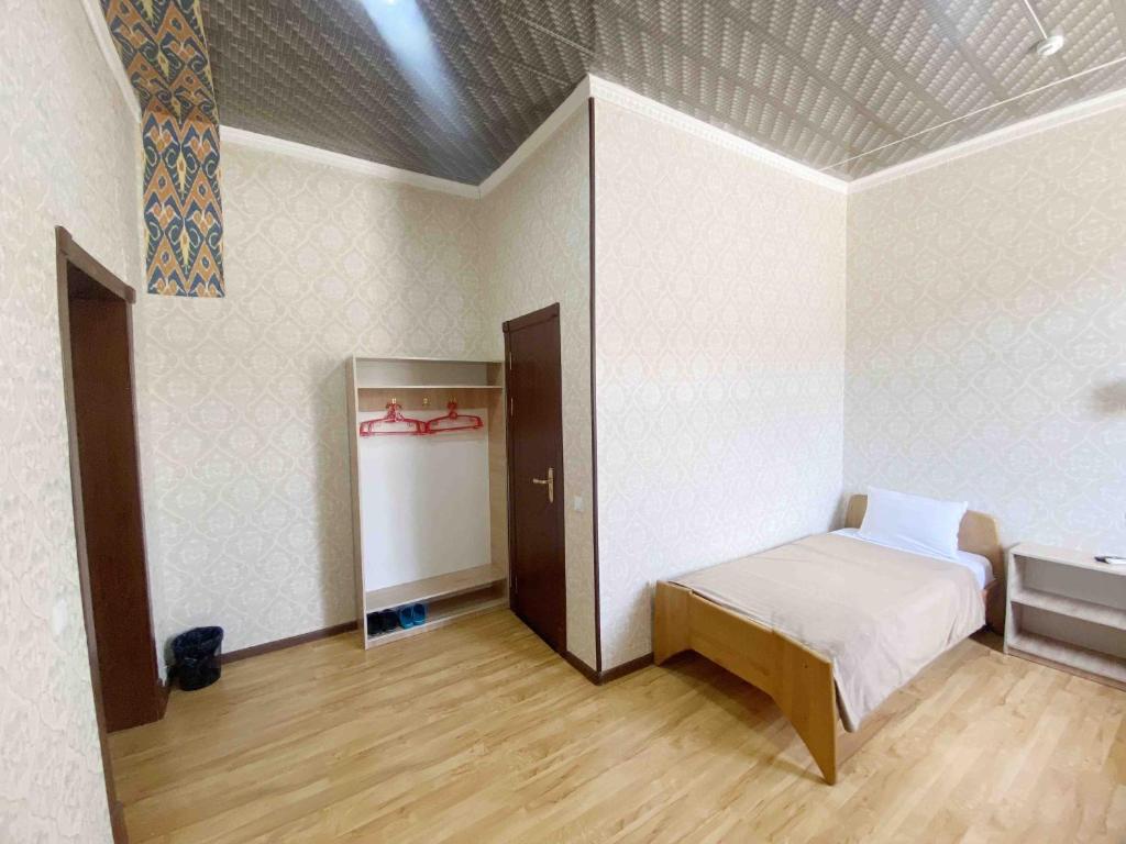希瓦Polvon Ota Hotel的一间设有床铺和水槽的客房