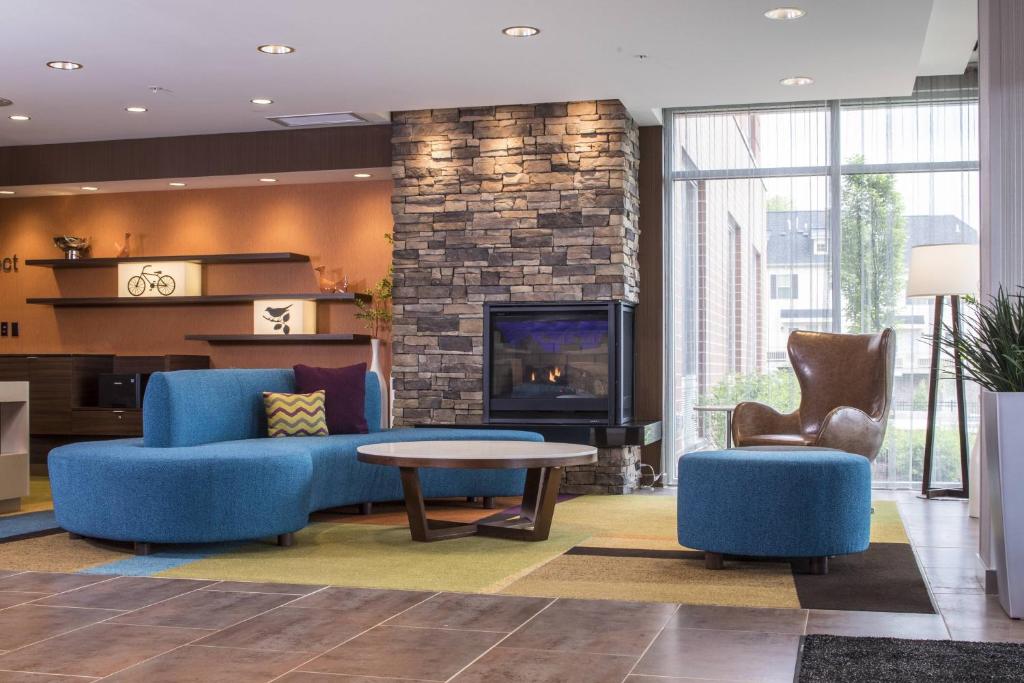 McCandless Township匹兹堡北/麦坎德利斯十字路口万豪费尔菲尔德客栈的客厅配有蓝色的家具和壁炉