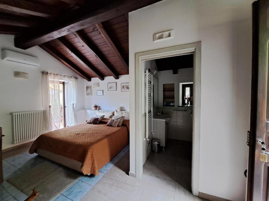特拉蒙蒂Agriturismo Il Tintore的一间卧室设有一张床和一间浴室。