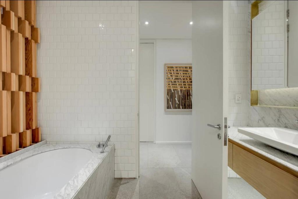 拉塞利亚Blair Atholl Estate的白色的浴室设有浴缸和水槽。