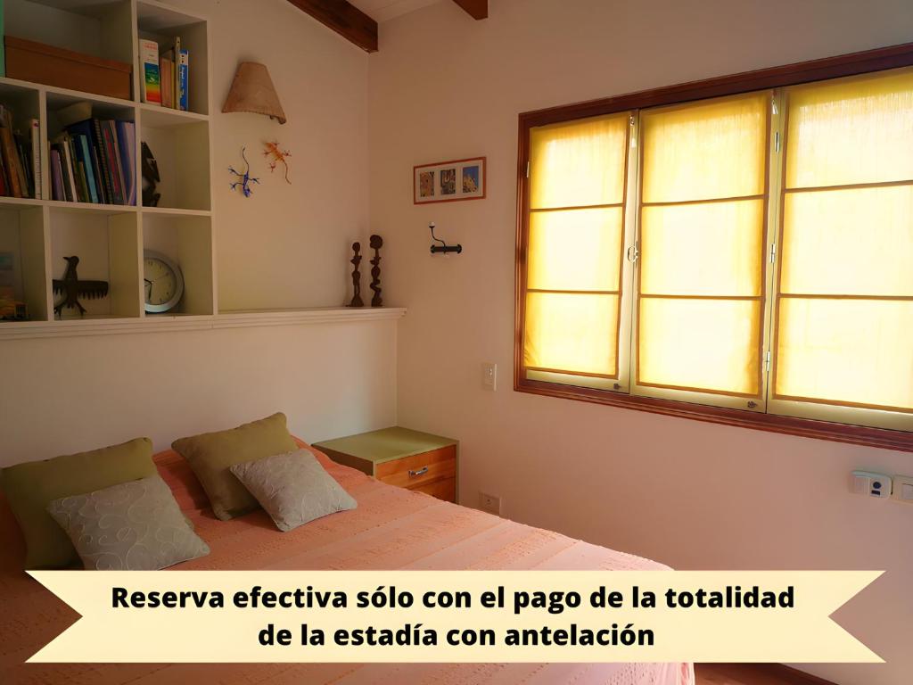 罗萨里奥CasaJardín的一间卧室设有一张床和一个窗口