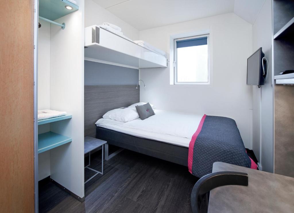 哥本哈根麦特龙卡宾酒店的小房间设有床和窗户
