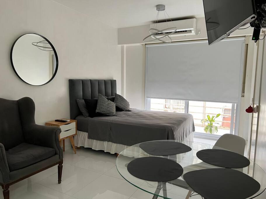 布宜诺斯艾利斯Buenos Aires City的卧室配有1张床、1张桌子和1把椅子