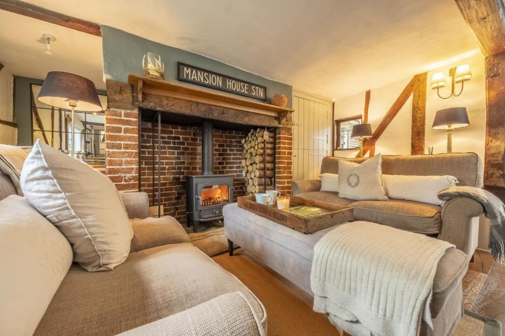 WenhastonWell Green Cottage的客厅设有两张沙发和一个壁炉
