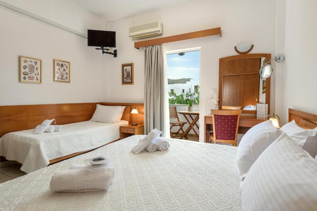 GrikosGrikos Hotel的酒店客房设有两张床和一个阳台。