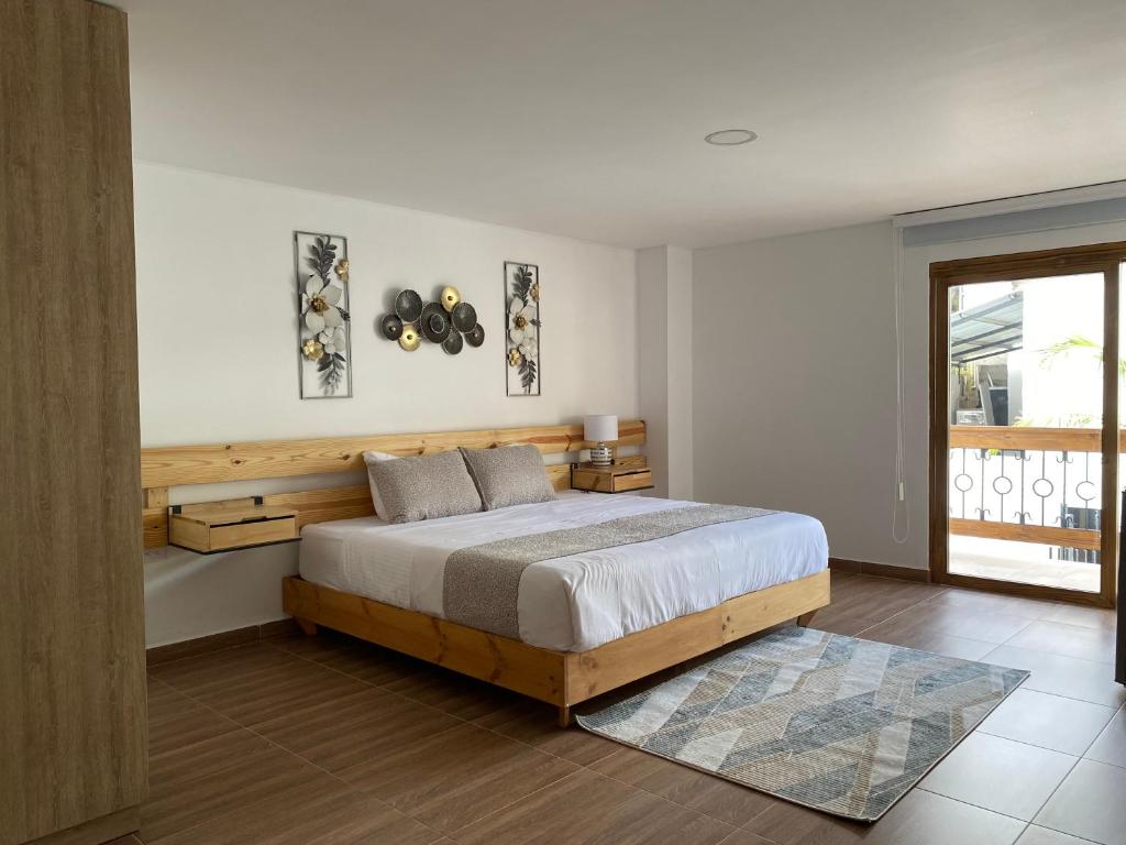 圣奥古斯丁Hotel Gran Plaza San Agustin的一间卧室设有一张大床和一个窗户。