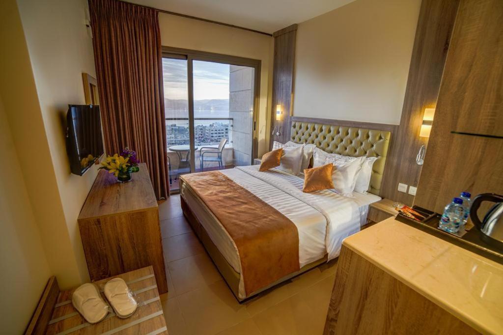 亚喀巴De-Lara hotel的酒店客房设有一张床和一个阳台。