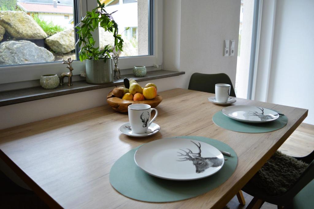 贝旺Alpenflair的木桌,盘子,杯子,一碗水果