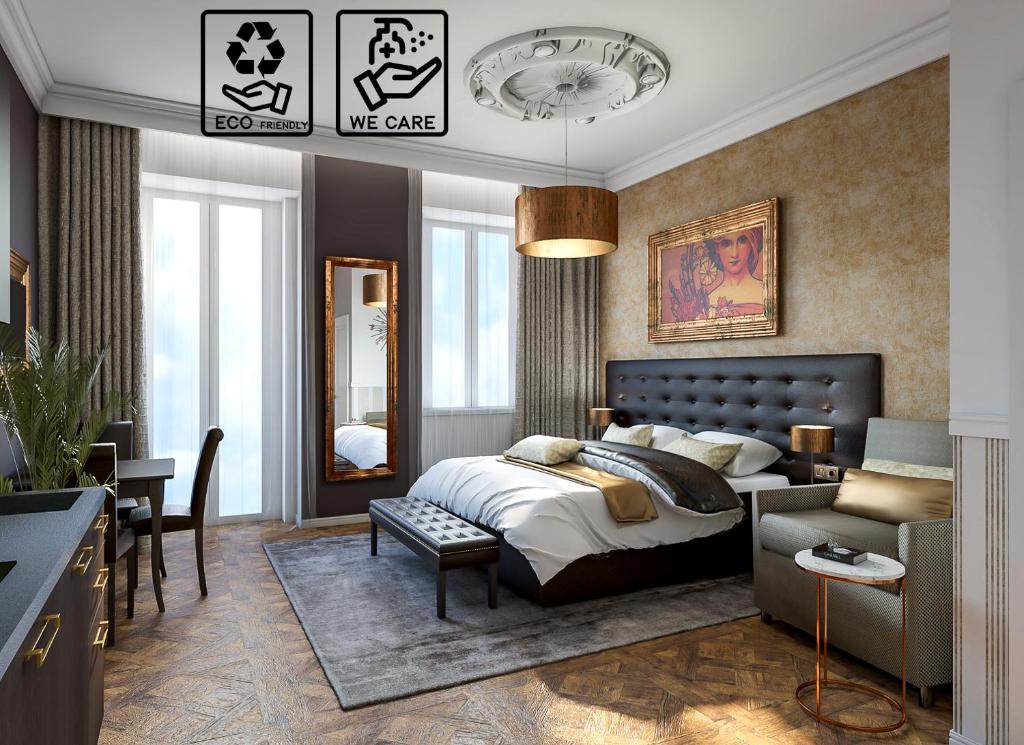 布拉格Alfons Boutique Hotel的一间卧室配有一张床、一张沙发和一张桌子