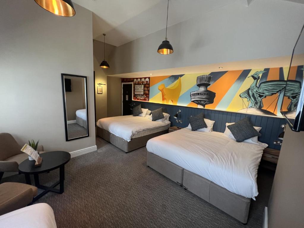 利物浦Fenwick Sunrise Hotel的酒店客房,设有两张床和镜子