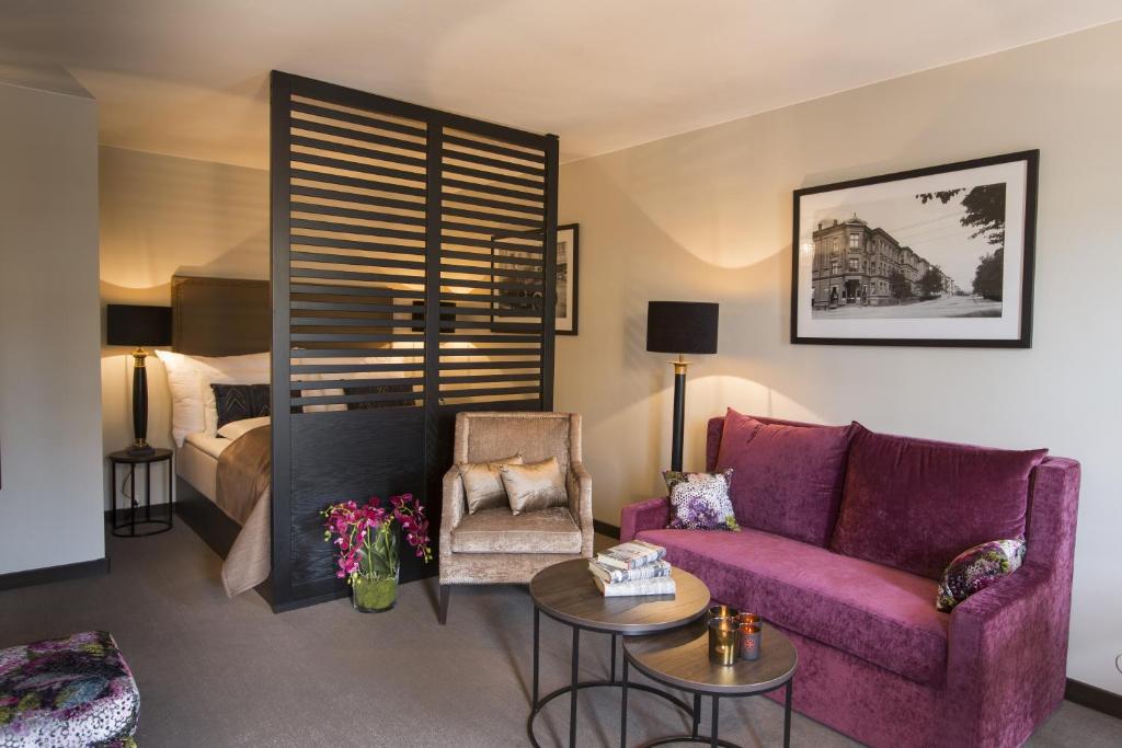 奥斯陆萨迦奥斯陆公寓的客厅配有紫色沙发和床。