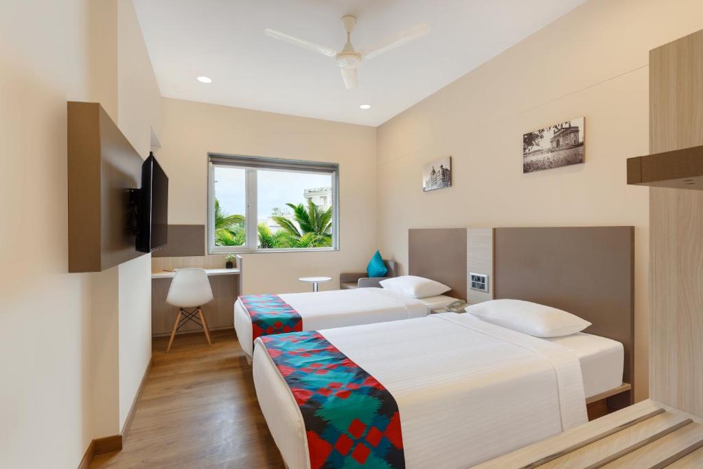 孟买Ginger Mumbai, Andheri的配有电视的酒店客房内的两张床