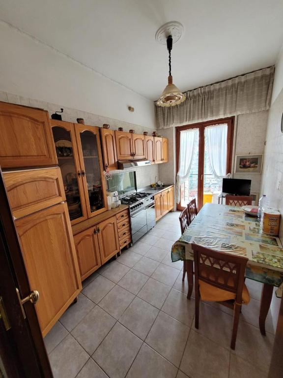阿韦利诺Avellino residence centralissimo的厨房配有桌子和木制橱柜。