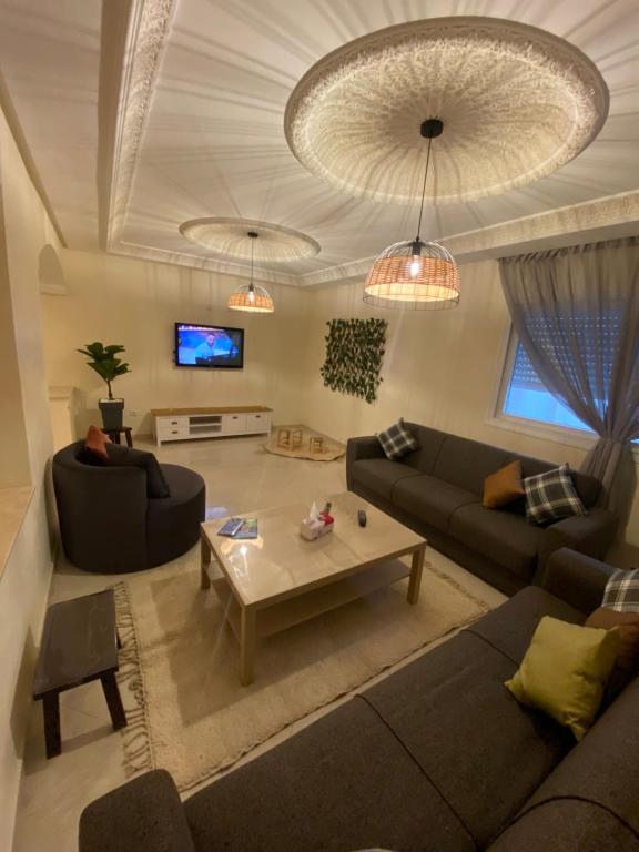 丹吉尔Appartement kenzi Beach的客厅配有两张沙发和一张咖啡桌