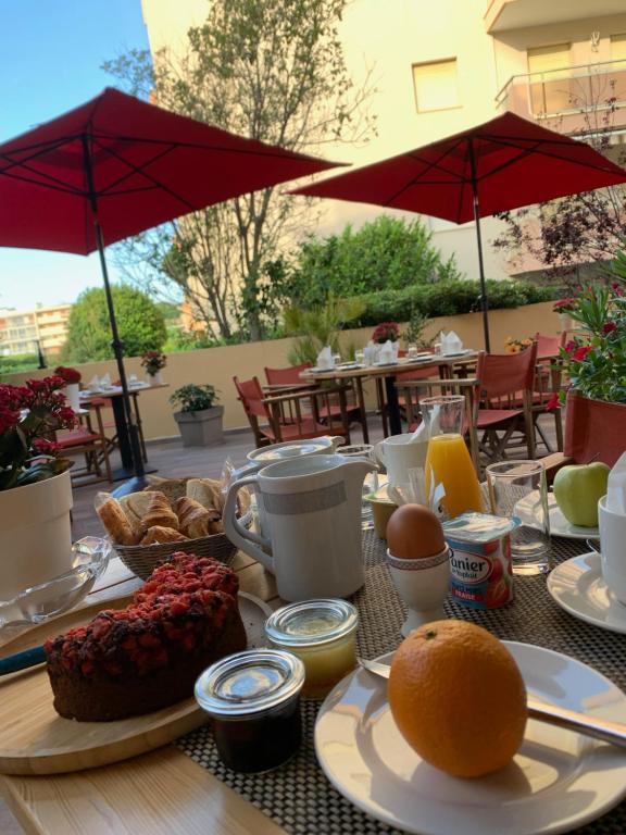 圣马克西姆小王子酒店的桌子上摆放着早餐食品,还有雨伞
