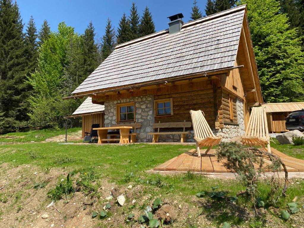Srednja Vas v BohinjuLovely Cottage in a mountain wilderness of the National Park的小木屋前方设有两把椅子