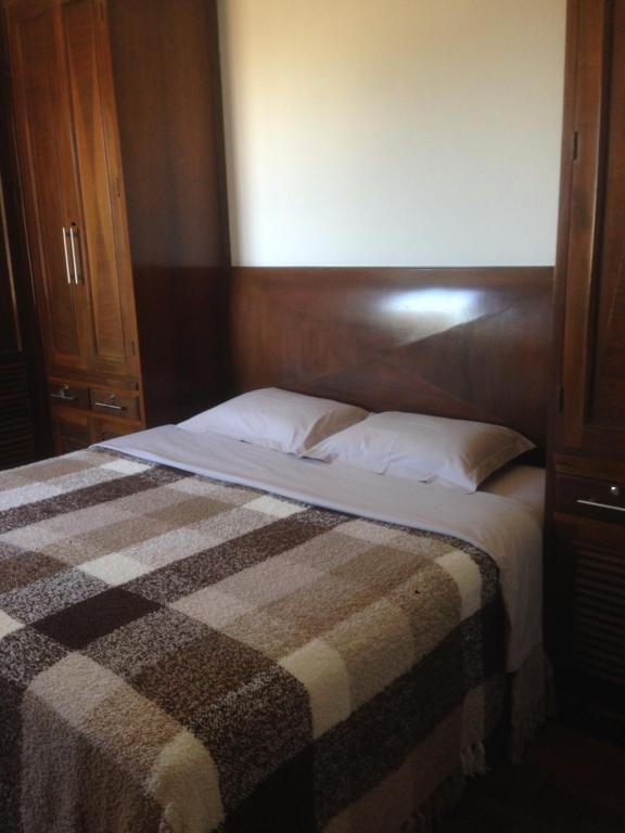 瓦尔任阿Aconchego 2 - Suíte的一间卧室配有一张带 ⁇ 子毯子的床