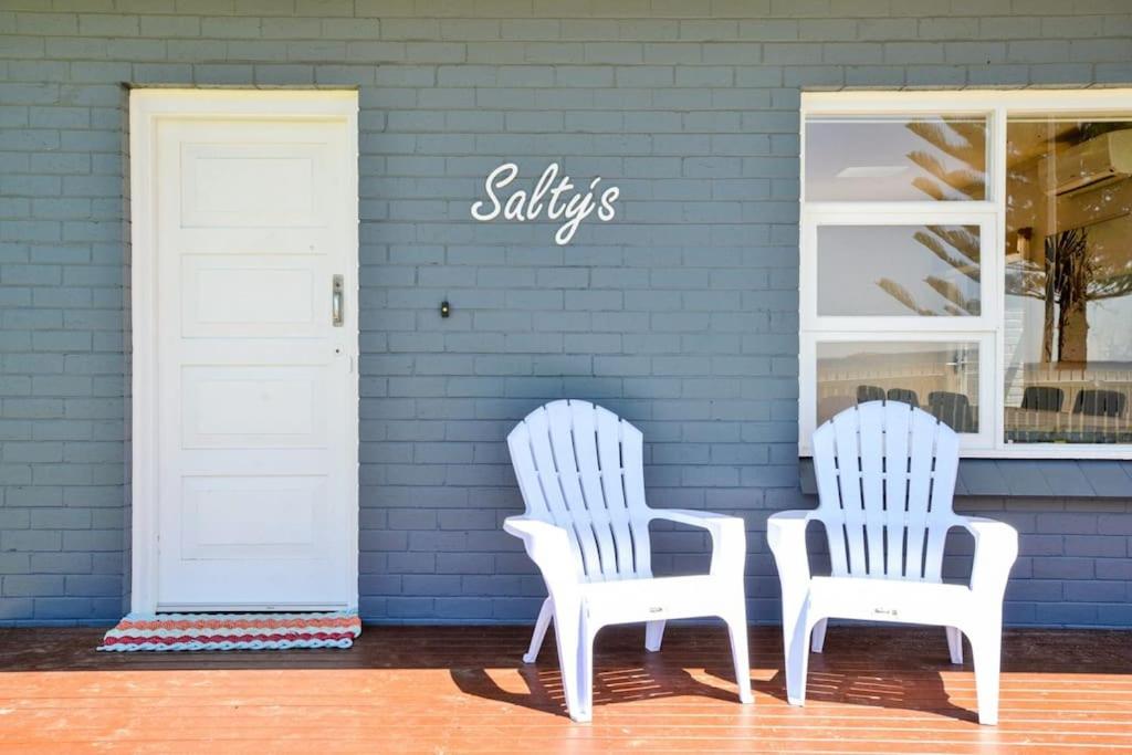 维克多港Saltys 4BRM Beachfront WIFI Pet Friendly的商店前有两把白色椅子