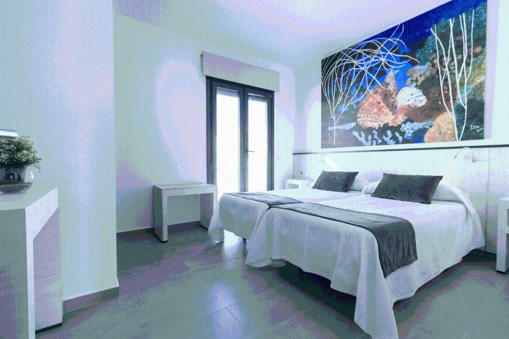 科尼尔-德拉弗龙特拉埃尔云克旅馆的卧室配有一张床,墙上挂着一幅大画