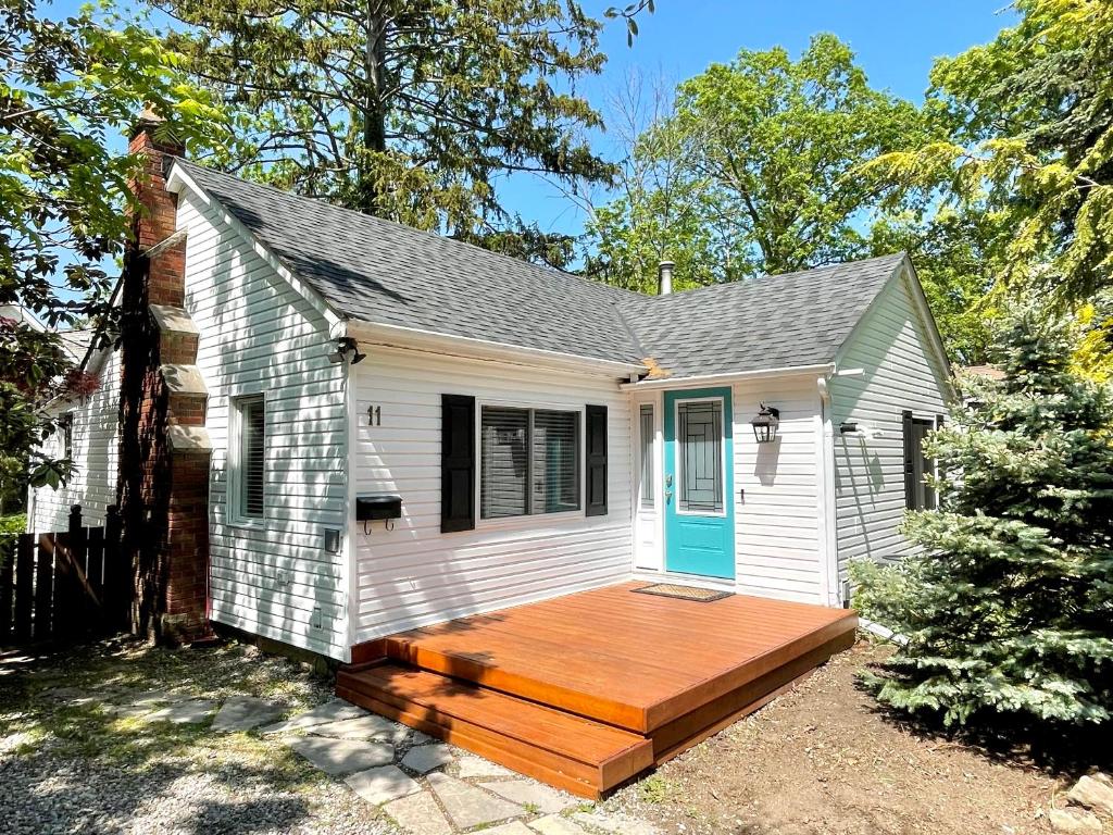 滨湖尼亚加拉Addison House License #041-2021的白色的小房子,设有木甲板