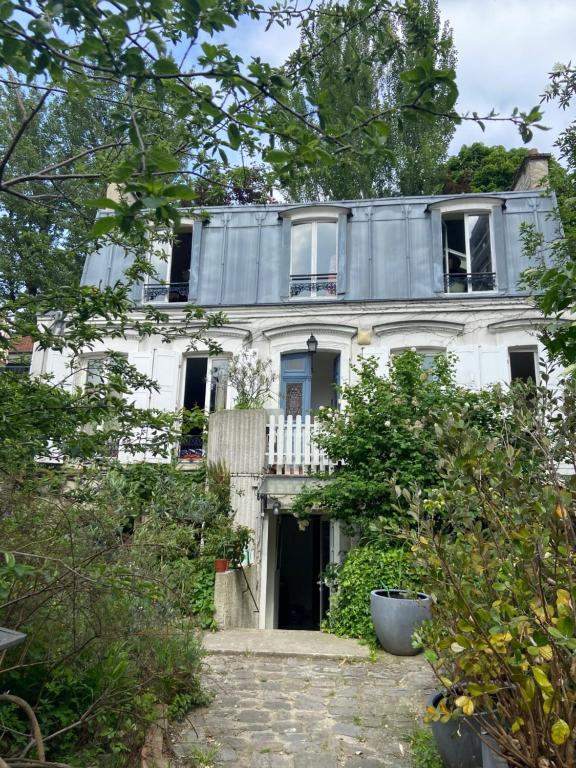 巴黎Le Grand Maulnes的白色的房子,上面设有阳台