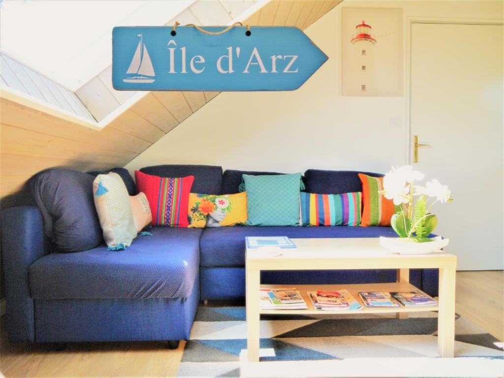 瓦讷13K Arz的客厅配有一张蓝色的沙发,配有一张桌子