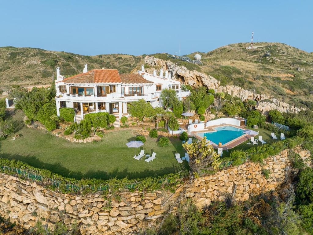 福尔内利斯Villa de lujo en Playa de Fornells的岩石墙房屋的空中景致