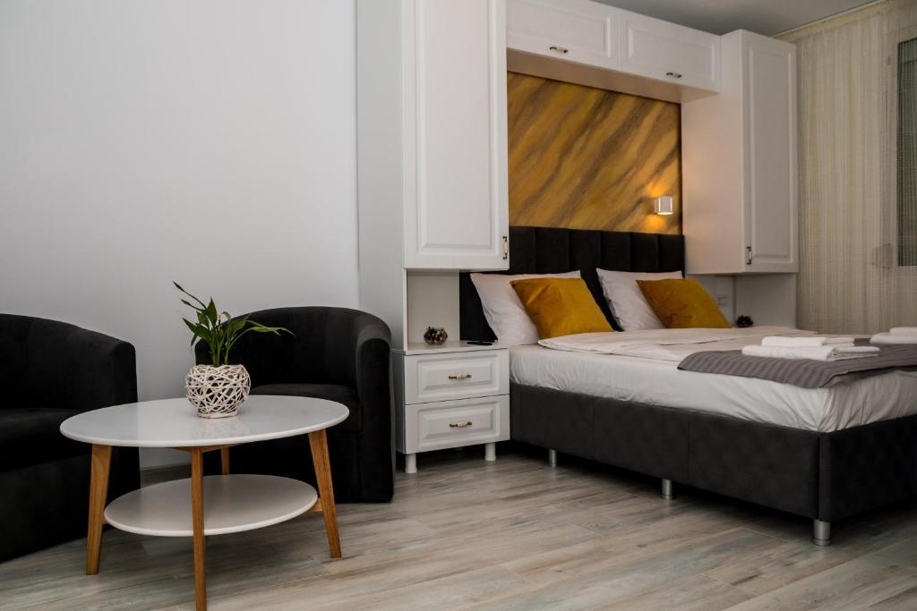 尼普顿Apartament Zeuss Neptun的卧室配有1张床、1张桌子和1把椅子
