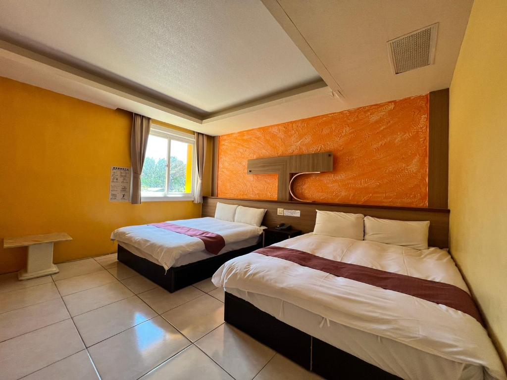 垦丁大街大尖山饭店的酒店客房设有两张床和窗户。