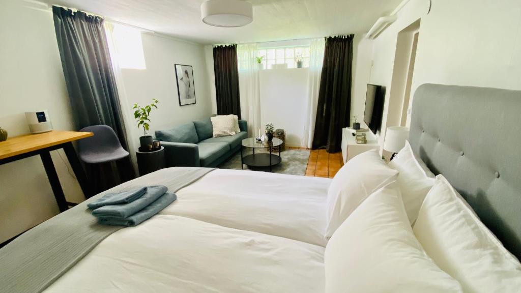 松兹瓦尔Sundsvall By M - Basement Studio的一间带白色床的卧室和一间客厅