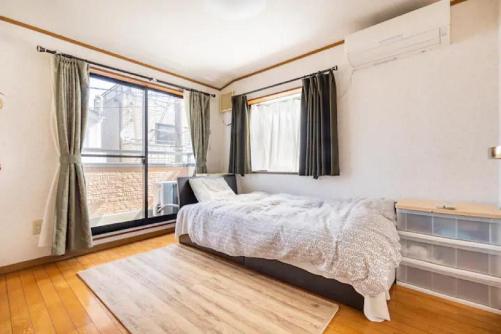 川崎Noriko's Home - Vacation STAY 13624的一间卧室设有一张床和一个大窗户