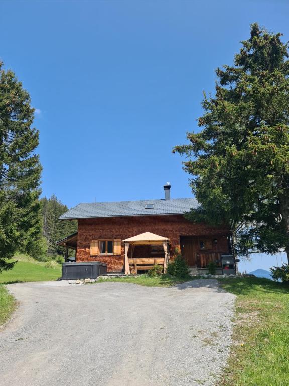 比尔塞贝格Burtscha Lodge im Sommer inklusive der Gästekarte Premium的前面有砂石车道的房子