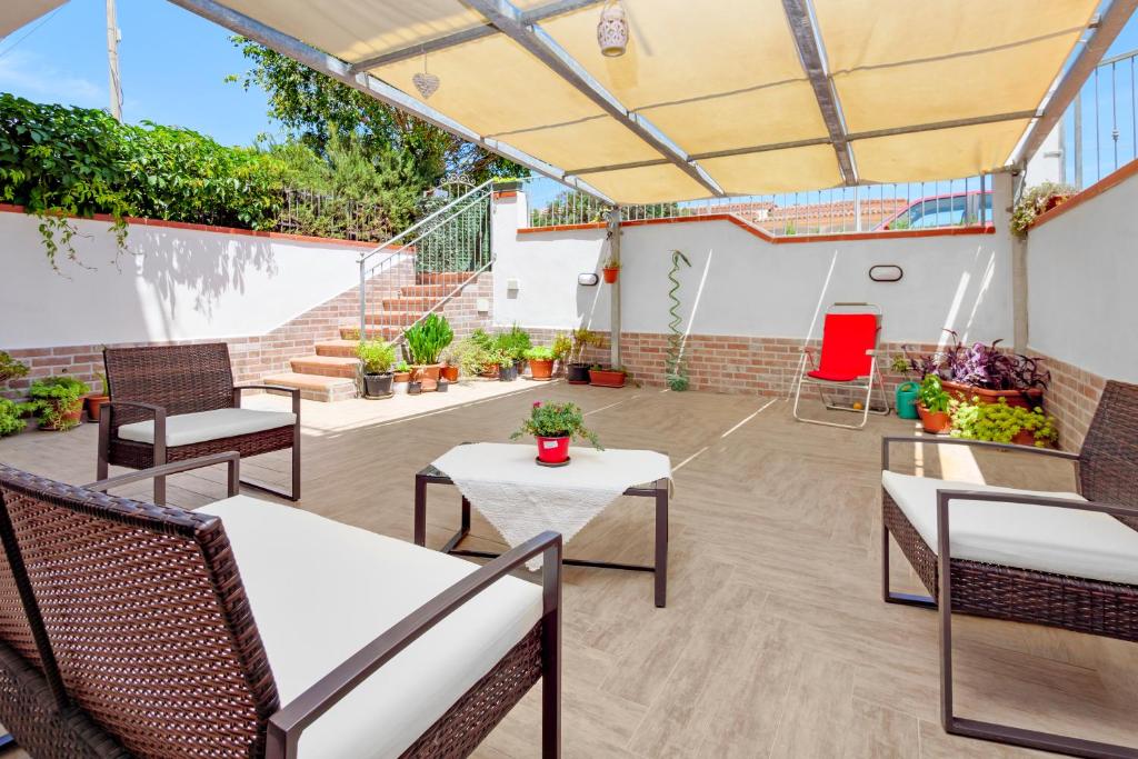 西尼斯科拉Appartamento Caterina的室外庭院设有桌椅和楼梯。