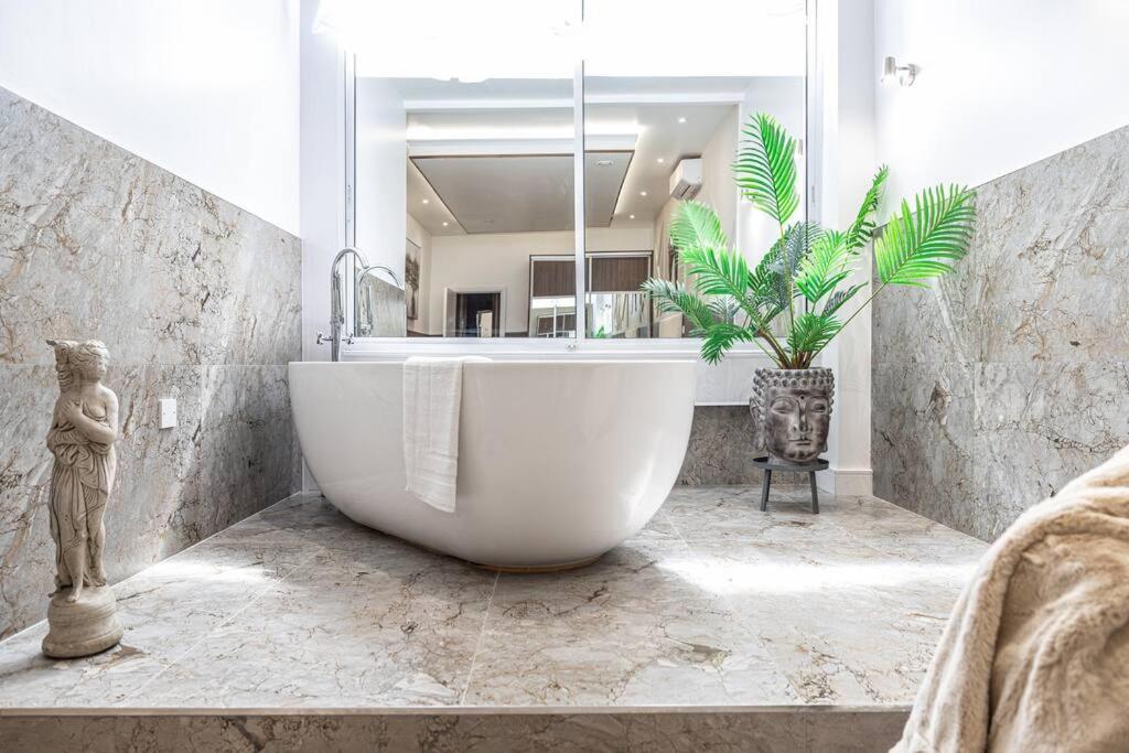 莱斯特The Pocklington - The Ceremonial Suite的植物浴室内的白色大浴缸