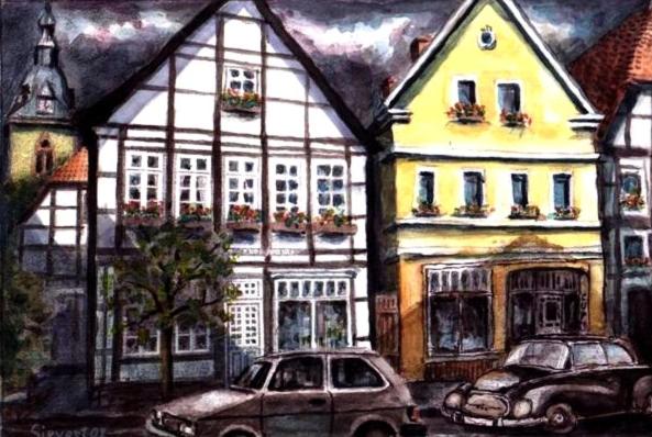 代特莫尔德Ferienwohnungen Café Cup的停在大楼前的两辆车的画