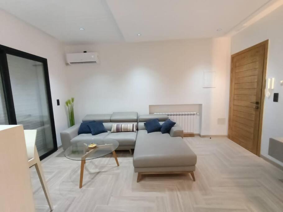 莫纳斯提尔Lovely apartment in Monastir的客厅配有沙发和桌子