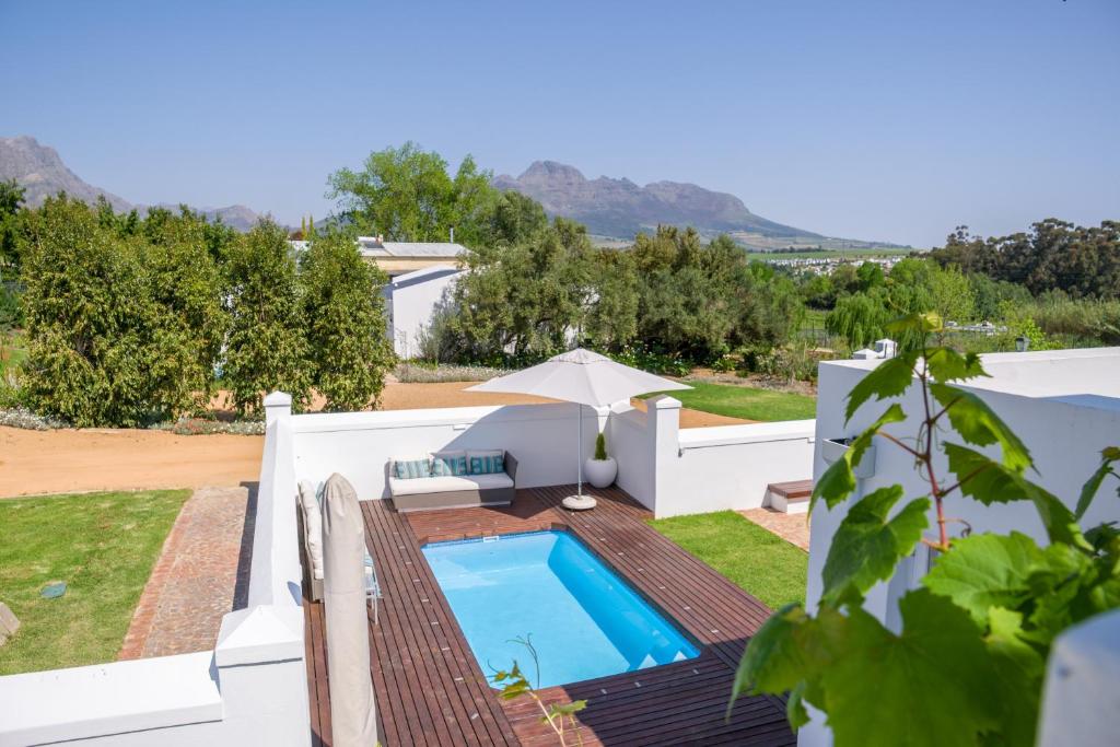 斯泰伦博斯Sunset Farm Stellenbosch的享有带游泳池的别墅后院的景致