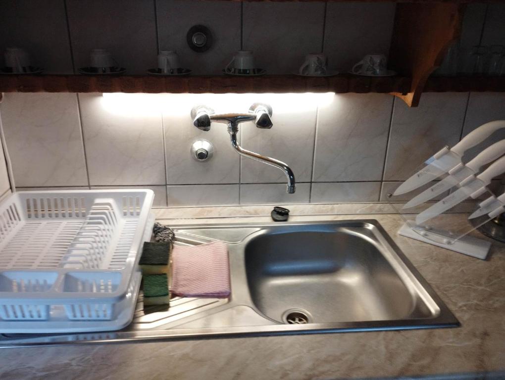 奥巴曹洛克Nóra Vendégház的厨房水槽旁设有碗碟干燥架