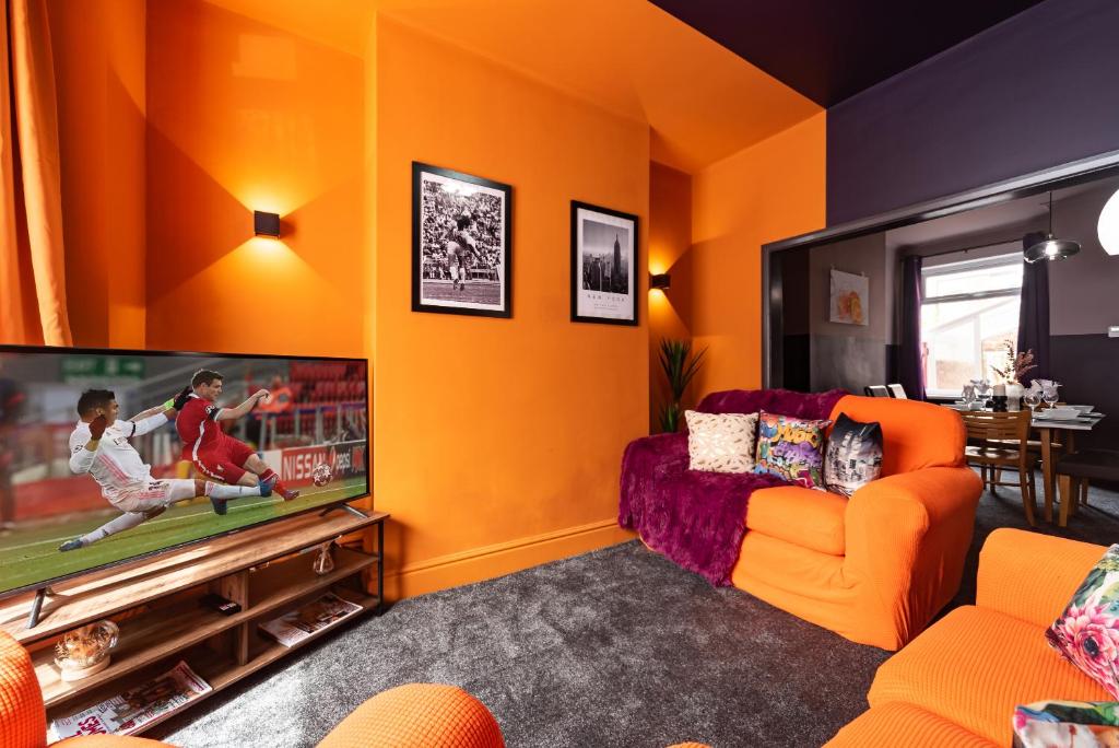赫尔Ephphatha 4 Beds Central A63 3 Bedrms Free Wifi的橙色的客厅配有电视和橙色沙发