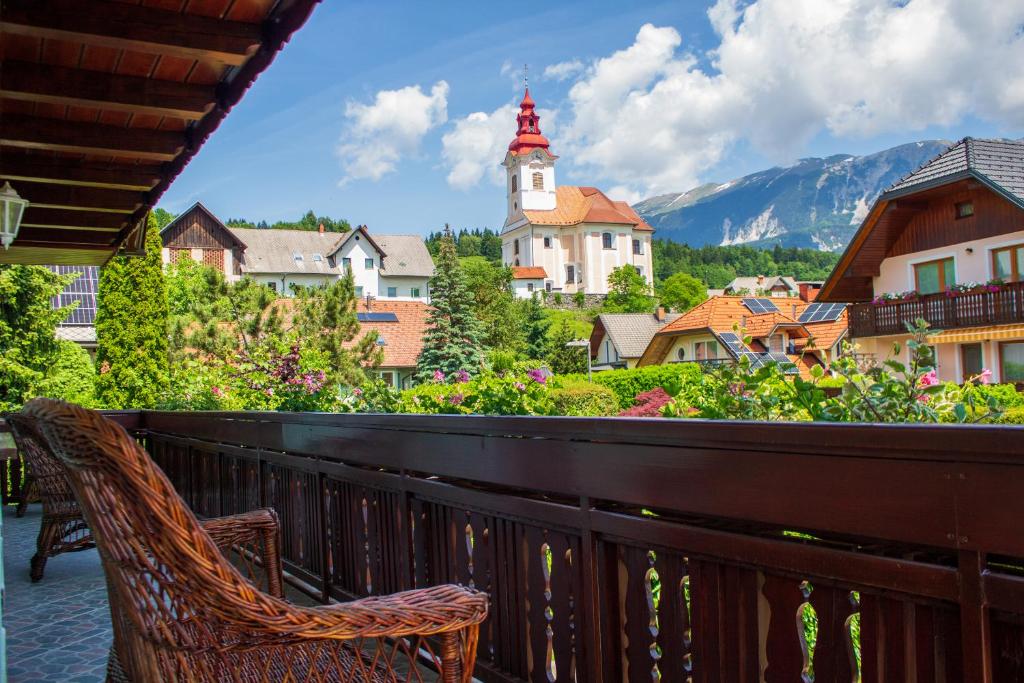Bled-RečicaLa casa verde的阳台配有椅子,享有城镇美景
