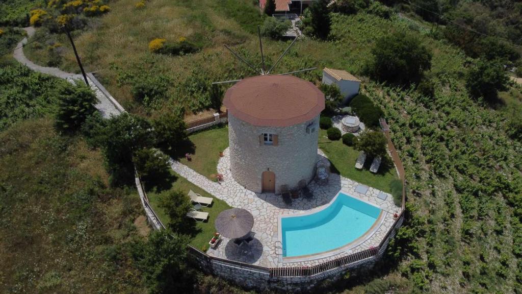 AsprogerakataAnemomilos Villa的享有塔楼和游泳池的空中景致