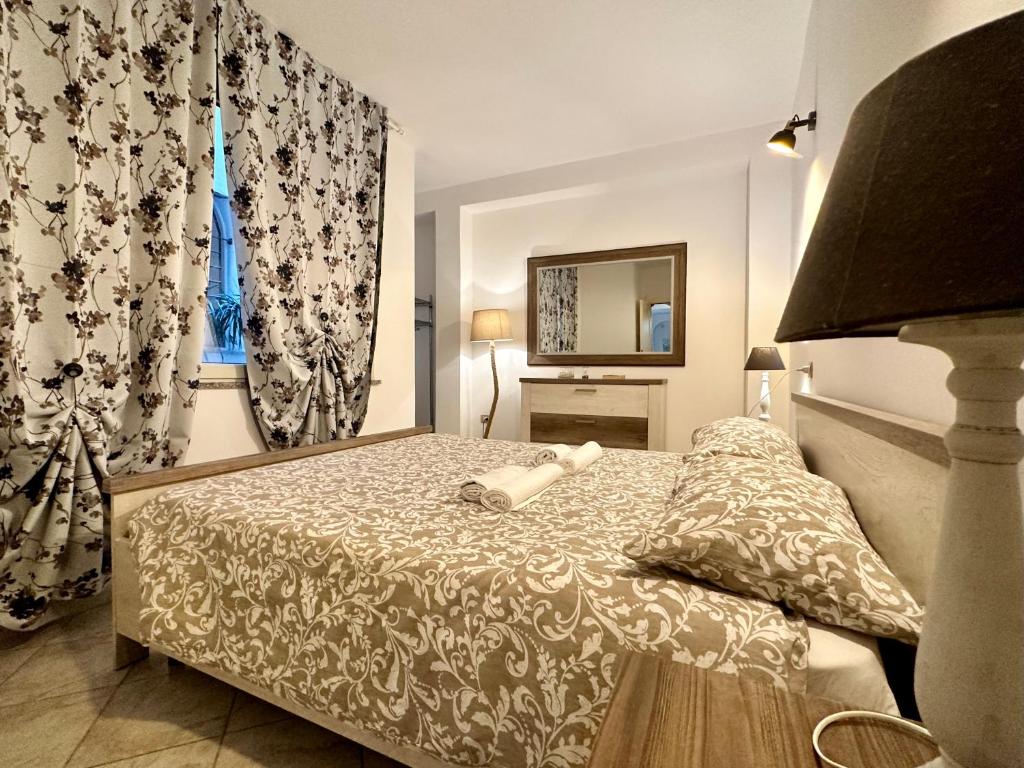 卡利亚里Arquer43 - Cagliari Old Town的一间卧室配有床、镜子和窗帘