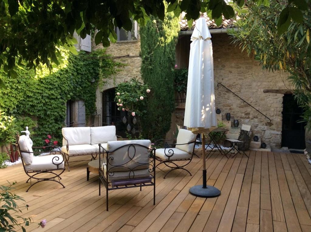 MaubecLa Maiz的庭院配有遮阳伞、椅子和桌子。