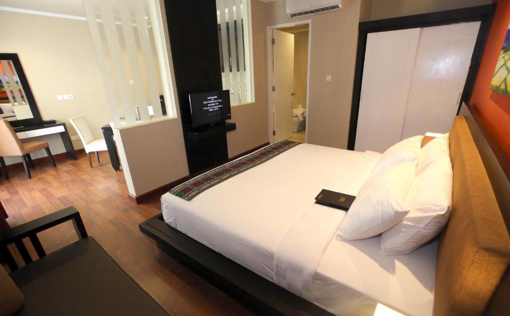 帝力诺瓦图里斯莫度假村及Spa酒店的一间卧室配有一张大床和一张书桌
