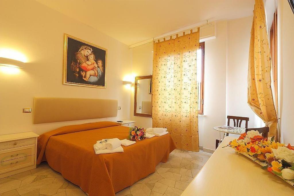 佛罗伦萨Arcadia GuestHouse的一间卧室配有带橙色床单的床和窗户。