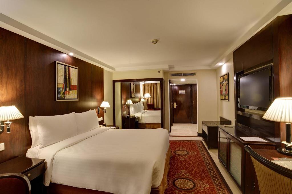伊斯兰堡伊斯兰堡万豪酒店 的卧室配有一张白色大床和电视。