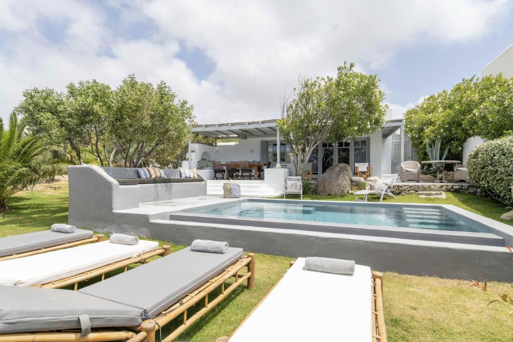 普拉迪斯亚罗斯Villa Valente in Mykonos with two pools!的后院设有游泳池和2张躺椅